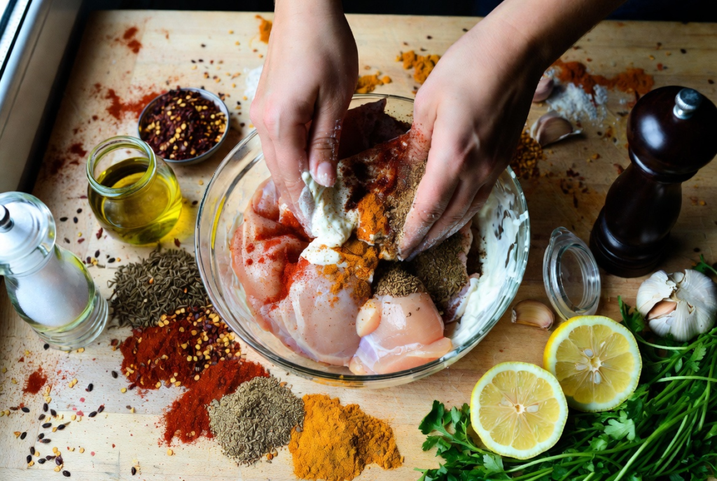 Marinating chicken in Greek yogurt with aromatic spices