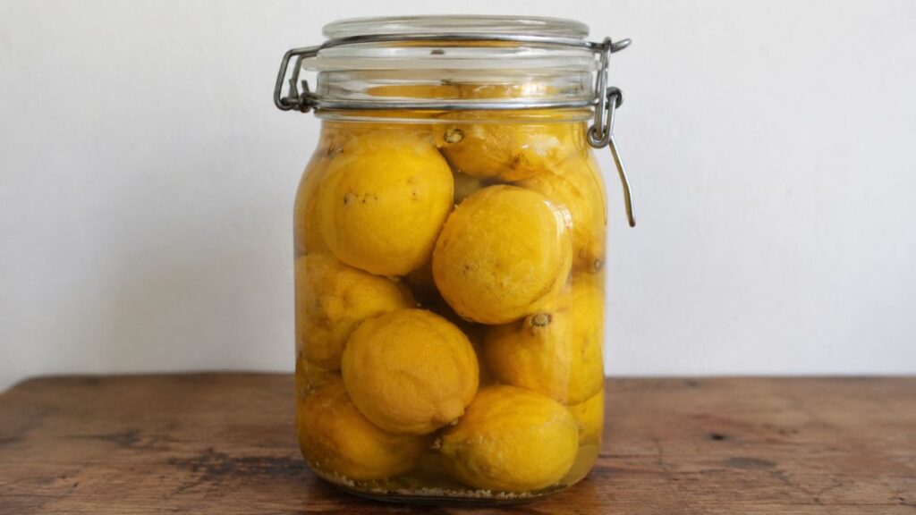 Homemade preserved lemons in a glass jar
