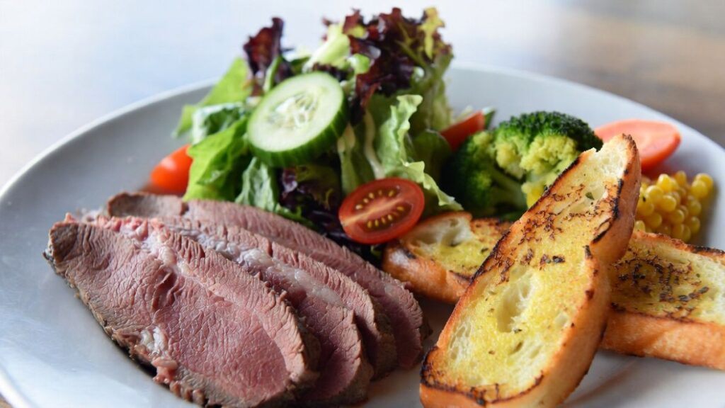 Side dishes including salad and garlic bread