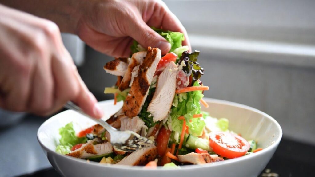 Mixing canned chicken salad ingredients together