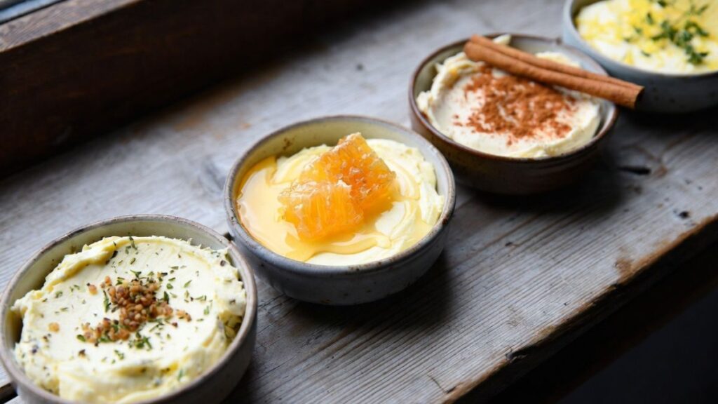 Homemade butter flavor variations with garlic herbs honey and cinnamon