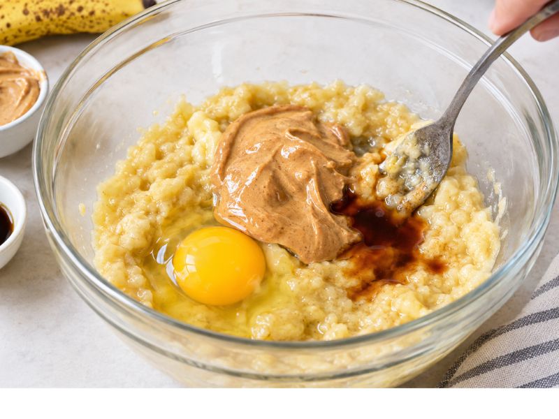 Mixing banana egg and nut butter for breakfast cookies