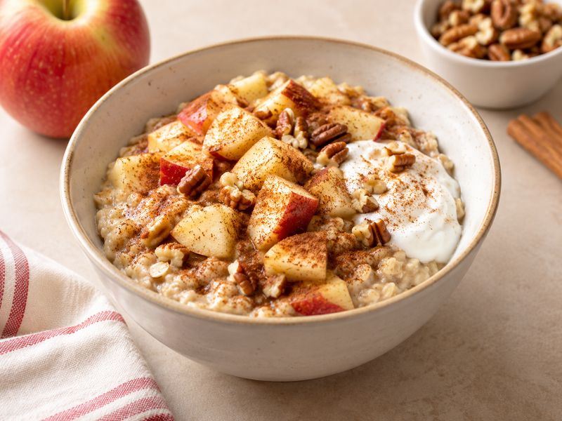 Apple cinnamon oatmeal with fruit and Greek yogurt for a low calorie breakfast
