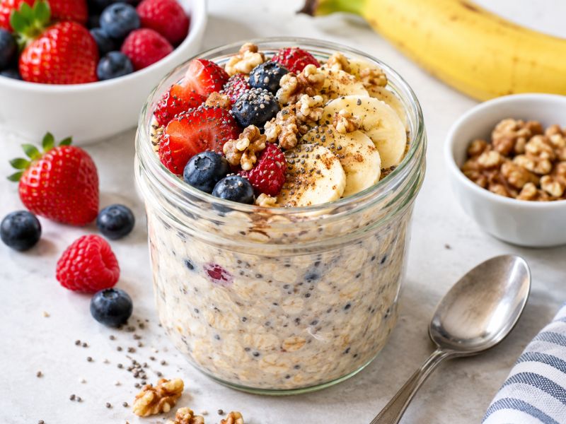 Six jars featuring berry, banana, apple, chocolate, strawberry, and tropical oat flavors