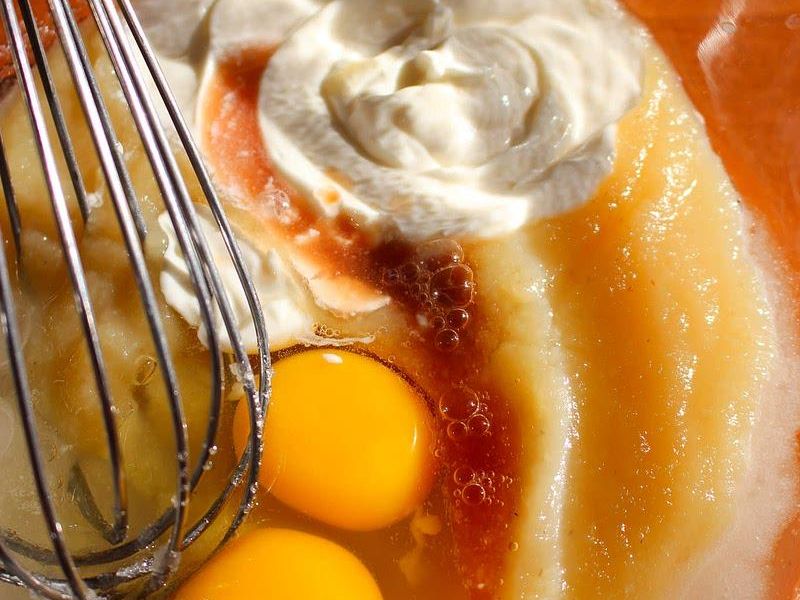 Applesauce, sugar, eggs, vegetable oil, and vanilla whisked together in a mixing bowl