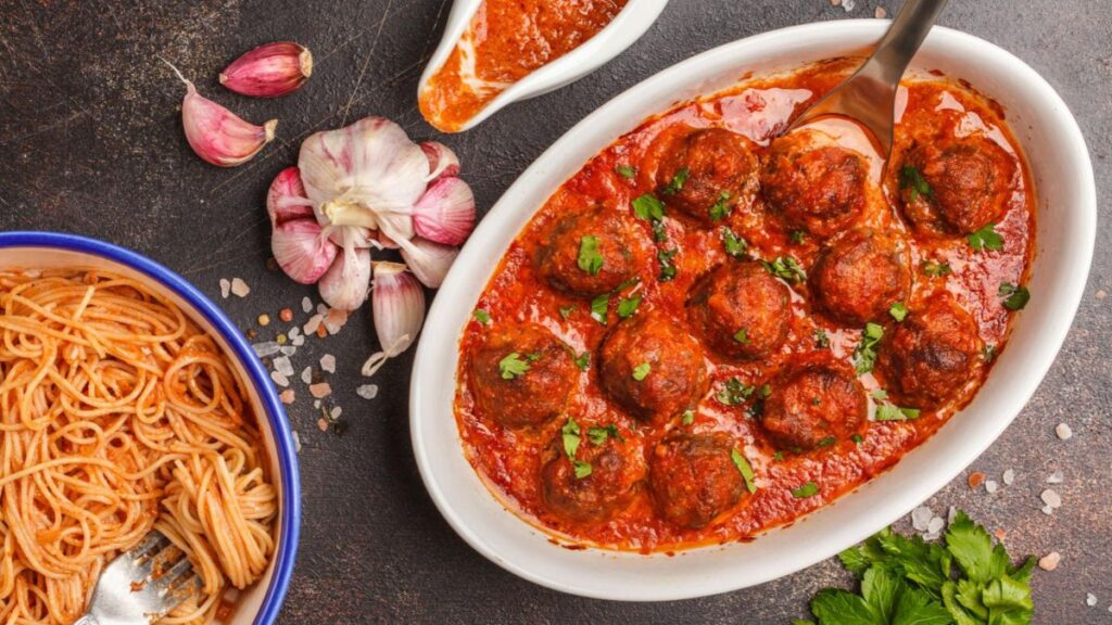 Baked beef meatballs in tomato sauce with lean ground beef, egg, breadcrumbs, garlic, and parsley