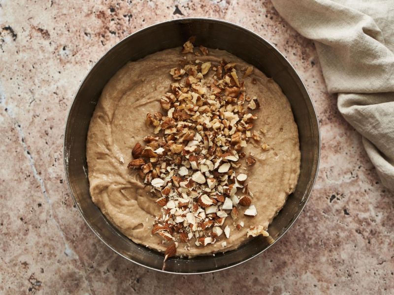 Banana cake batter spread evenly in a lined baking pan