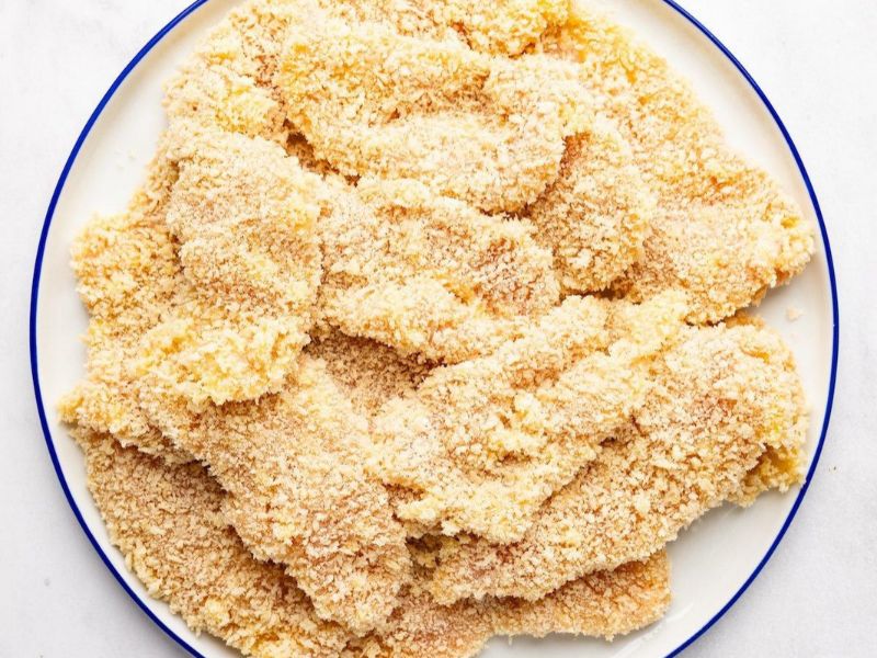 Breaded chicken cutlets evenly coated with panko breadcrumbs before cooking