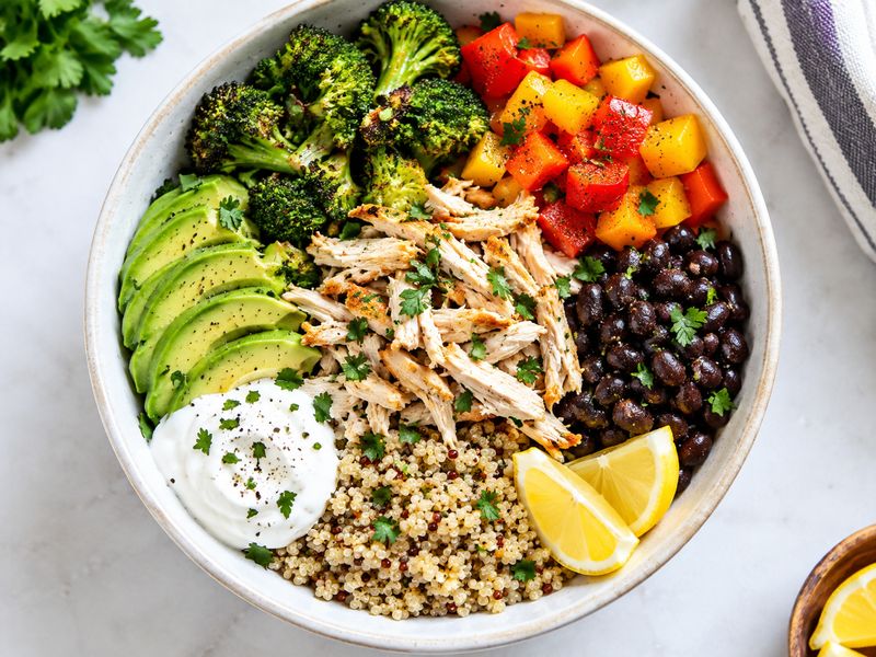 Fresh avocado salad with greens, cucumber, tomatoes, and red onion