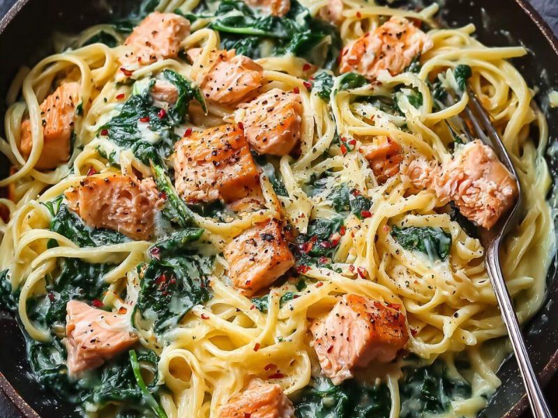Creamy spinach sauce with grated Parmesan in a skillet